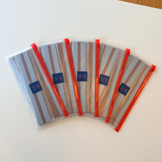 Set of six striped pouches with red zippers on a white surface.